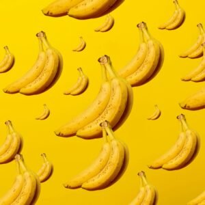 A creative and vibrant pattern of bananas against a bright yellow background, ideal for lively designs.